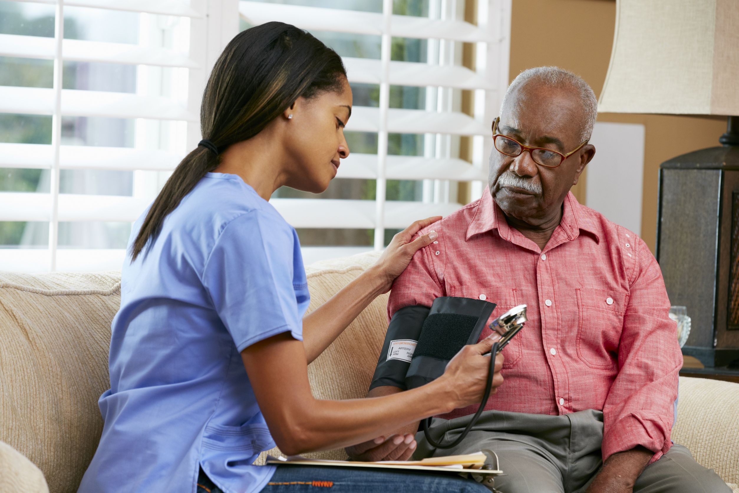 18735726 – nurse visiting senior male patient at home